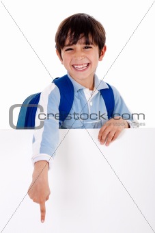 Young school boy showing hins fingers down from behind the board
