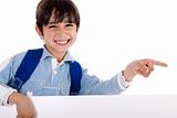 Happy young boy pointing to copy sapce
