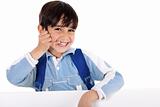 Smiling young boy acts as he talks over phone