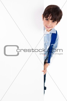 Young kid silently standing behind the board