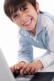 Portrait of cute caucasian boy smiling with laptop