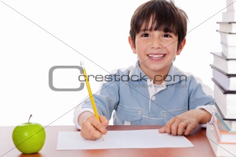 School boy doing his homework with an apple beside him