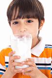 Happy kid drinking glass of milk
