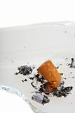 cigarette on a broken ashtray isolated on white