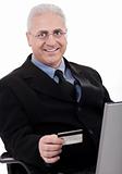Senior business man making online purchase with his credit card