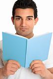 Man looking up from an open book