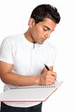 Man or student writes in a notebook