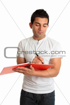 Man or student writing in a notebook