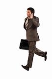 Business man running with a briefcase and speaking by phone