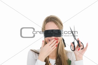 Girl wearing black band on his eyes and holding scissors