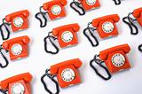 large group of orange telephones