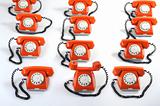 large group of orange telephones