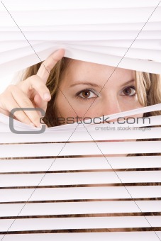 woman hands apart on the window blinds