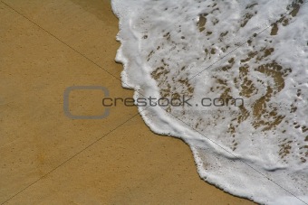 white wave in the sand at the beach