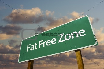 Fat Free Zone Green Road Sign In Front of Dramatic Clouds and Sky.