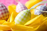 Easter eggs on yellow tulip petals