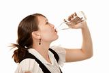 Profile of woman drinking water from a glass bottle
