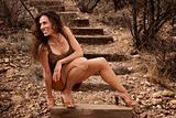 Portrait of pretty woman outdoors on wooden steps