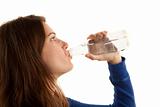Pretty brunette woman drinking water on white background