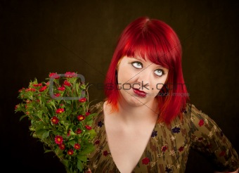 Pretty punky girl with brightly dyed red hair and flowers