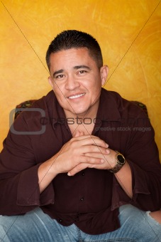 Handsome Hispanic Man Seated in Colorful Chair