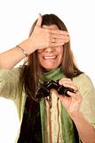Woman covering her eyes after using binoculars