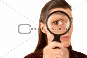 Pretty adult woman using magnifying glass