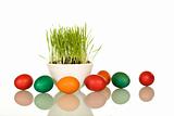 Easter symbols - fresh green grass and colorful eggs