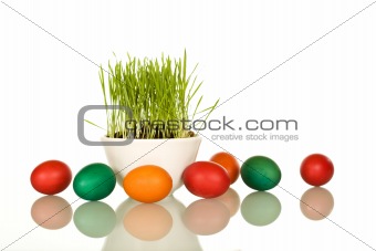 Easter symbols - fresh green grass and colorful eggs
