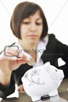 business woman putting coins money in piggy bank