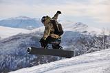 freestyle snowboarder jump and ride