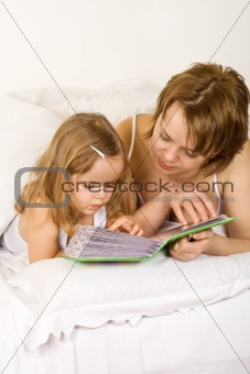 Memories - little girl and woman looking at a photo album