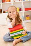 Little girl with a stack of books