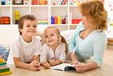 Kids having fun reading stories with their mom