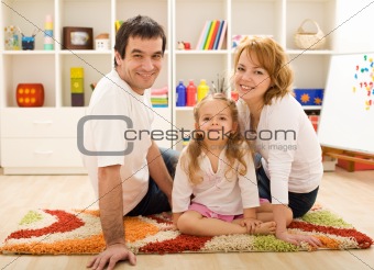Happy family together sitting on the floor