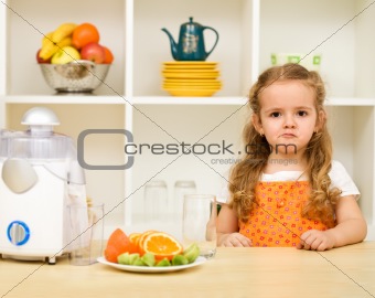 Little girl making faces - fruit juice again ?