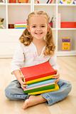 Happy little girl with books
