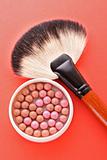  cosmetic brush and rouge on the red background