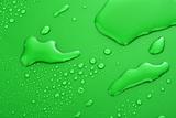 Green water drops background with big and small drops 