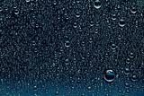 Water drops on a dark blue glass surface