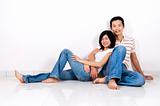 Couple sitting on floor at home.