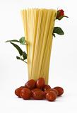 raw spaghetti with tomato base and a red rose