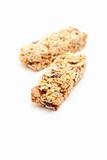 Two Nutritious Granola Bars Isolated on White with narrow Depth of Field. 
