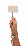 Handcuffed Woman Holding Blank White Sign Isolated on a White Background - Ready for Your Own Message.