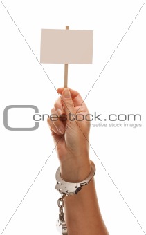 Handcuffed Woman Holding Blank White Sign Isolated on a White Background - Ready for Your Own Message.