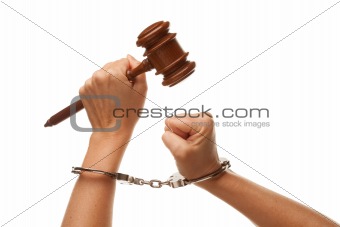 Handcuffed Woman Holding Wooden Gavel in Her Fist Isolated on a White Background.