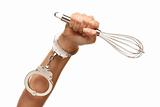 Handcuffed Woman Holding Egg Beater in the Air Isolated on a White Background.