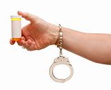 Handcuffed Man Holding Blank Medicine Bottle Isolated on a White Background.