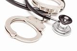 Stethoscope and Handcuffs Isolated on a White Background.