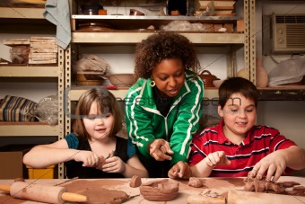 Teacher and students in clay studio
